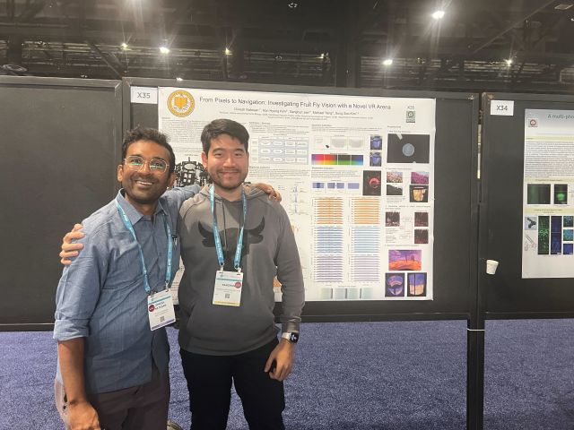 In front of the poster